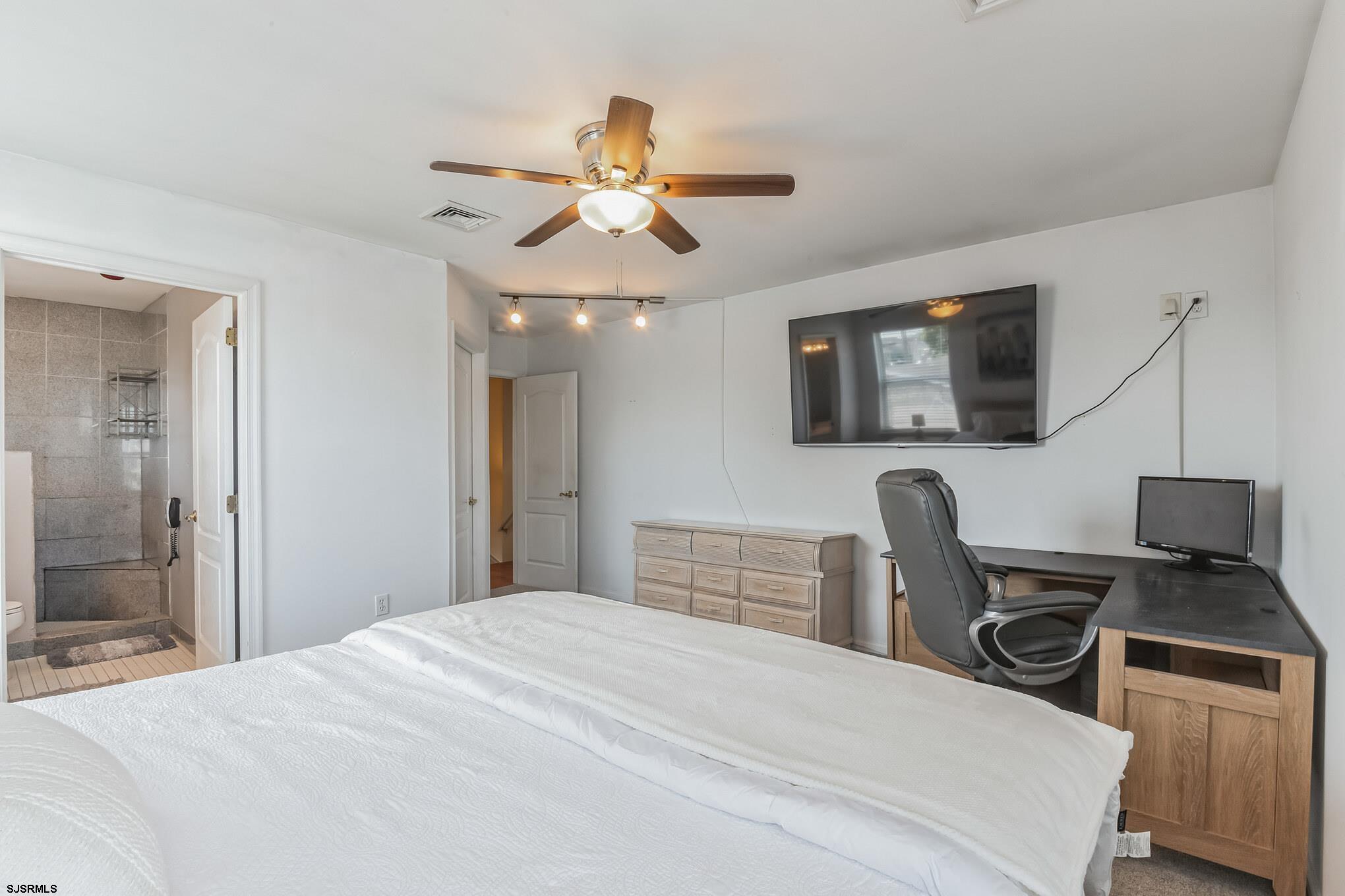 1 MacDonald Place Brigantine, NJ 08203 - Photo 16 of 36 a bedroom with a bed and a flat screen tv