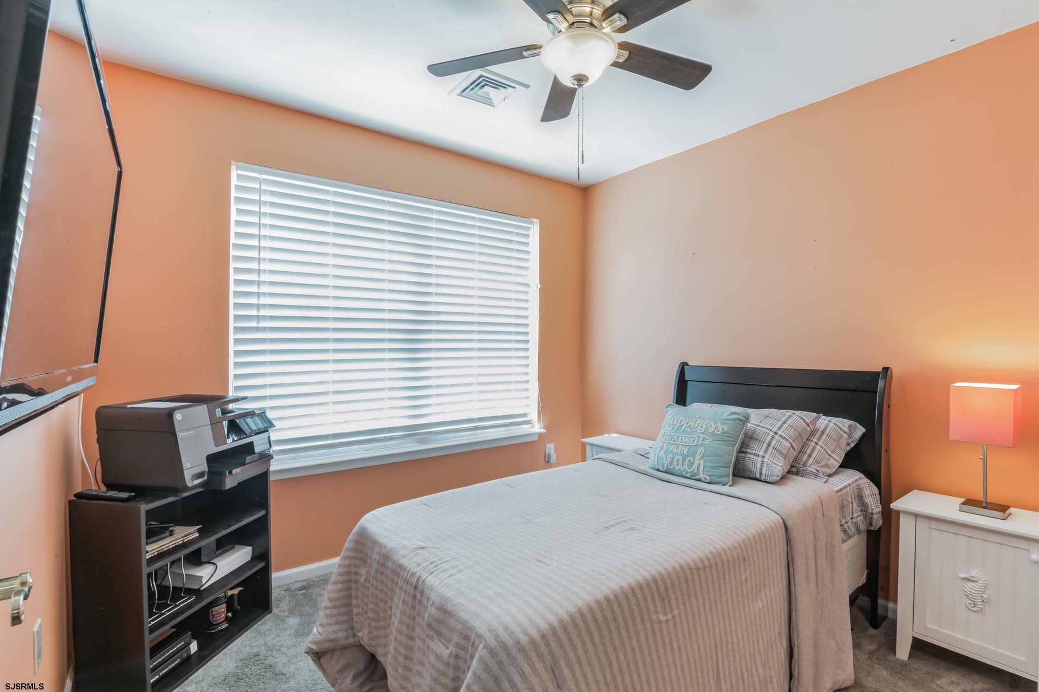 1 MacDonald Place Brigantine, NJ 08203 - Photo 20 of 36 a bedroom with a large bed and a chandelier