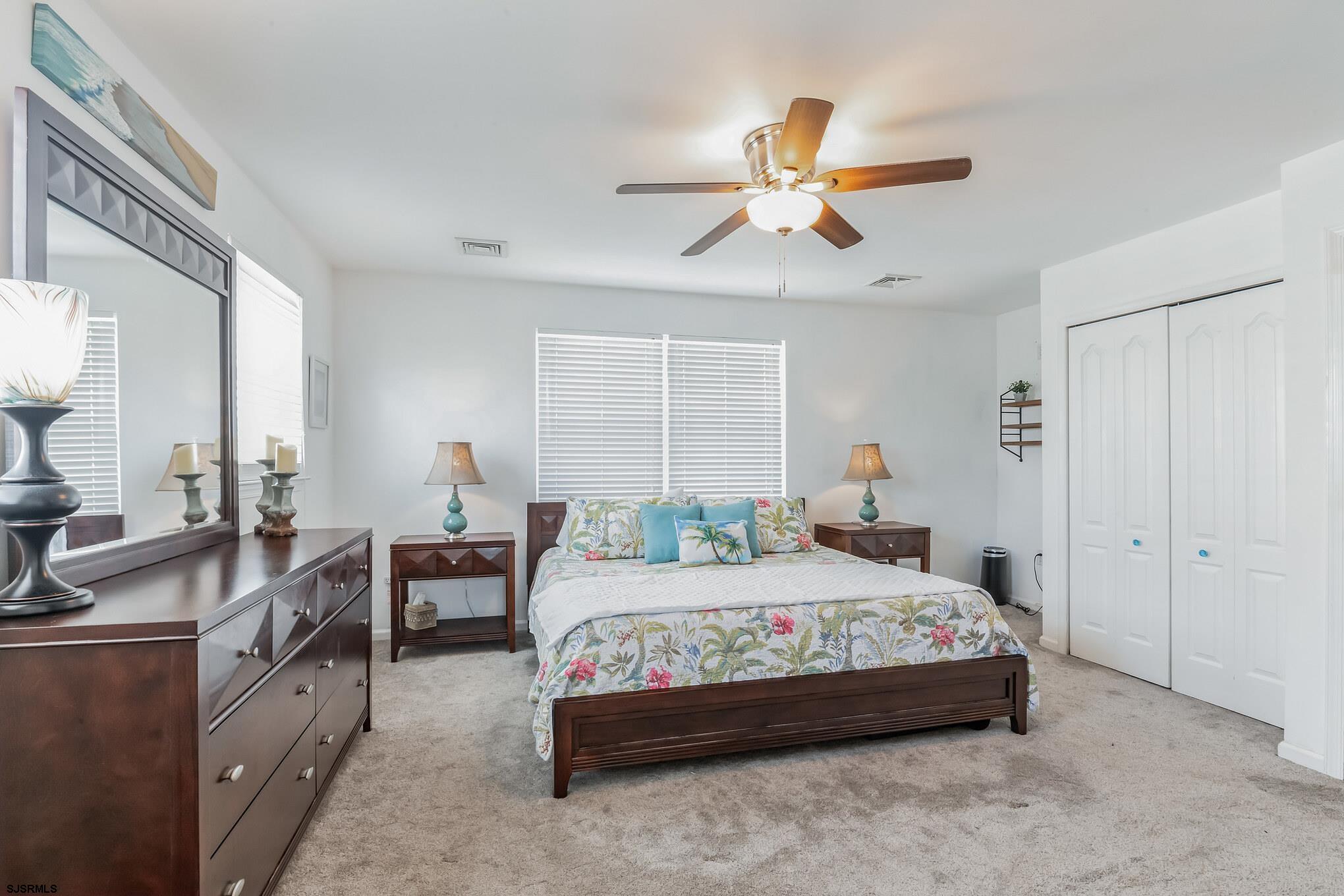 1 MacDonald Place Brigantine, NJ 08203 - Photo 21 of 36 a bedroom with a bed and a chandelier
