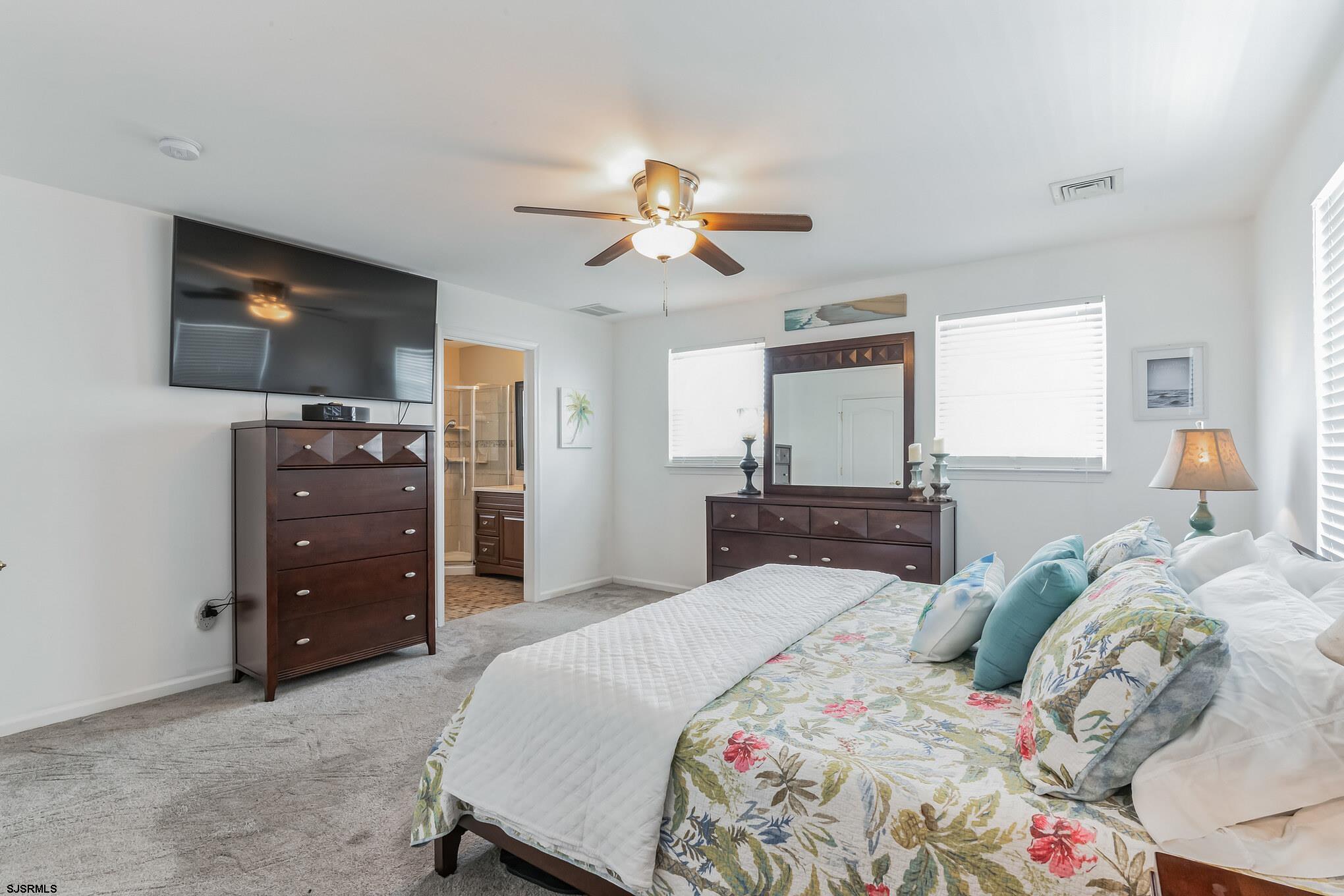 1 MacDonald Place Brigantine, NJ 08203 - Photo 22 of 36 a bedroom with a bed and a chandelier