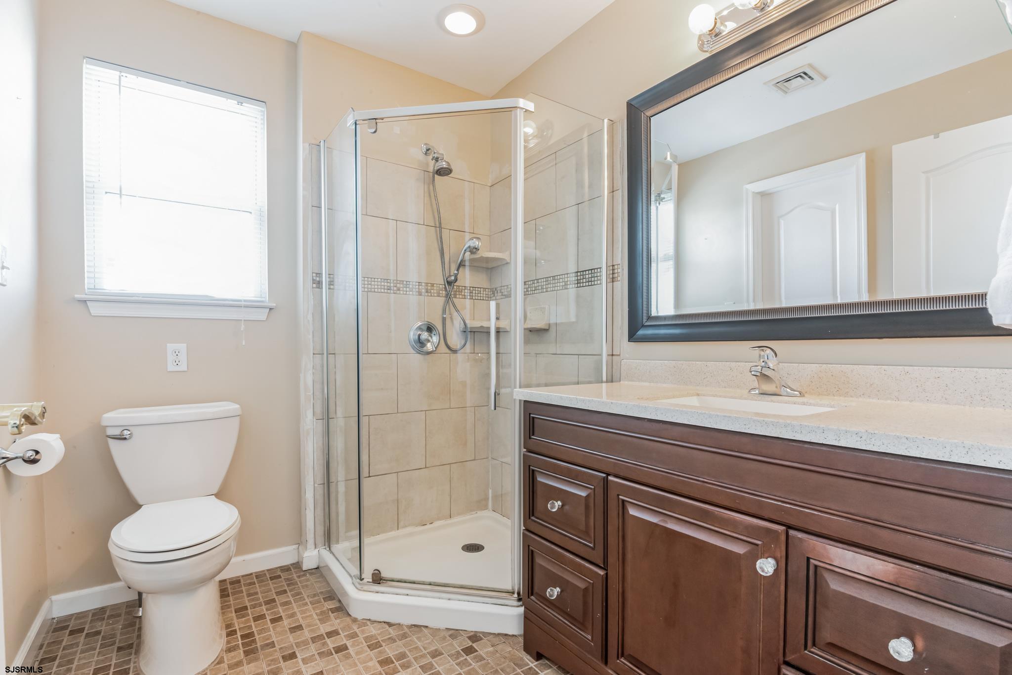 1 MacDonald Place Brigantine, NJ 08203 - Photo 23 of 36 a bathroom with a sink a toilet and shower