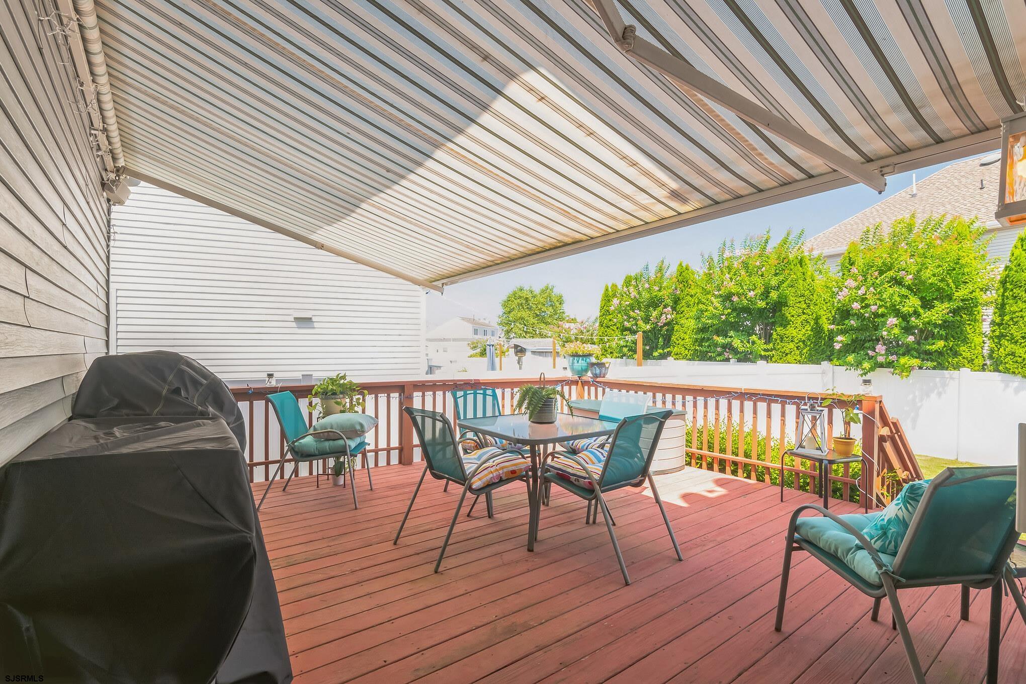 1 MacDonald Place Brigantine, NJ 08203 - Photo 25 of 36 a view of a chair and table on the wooden deck