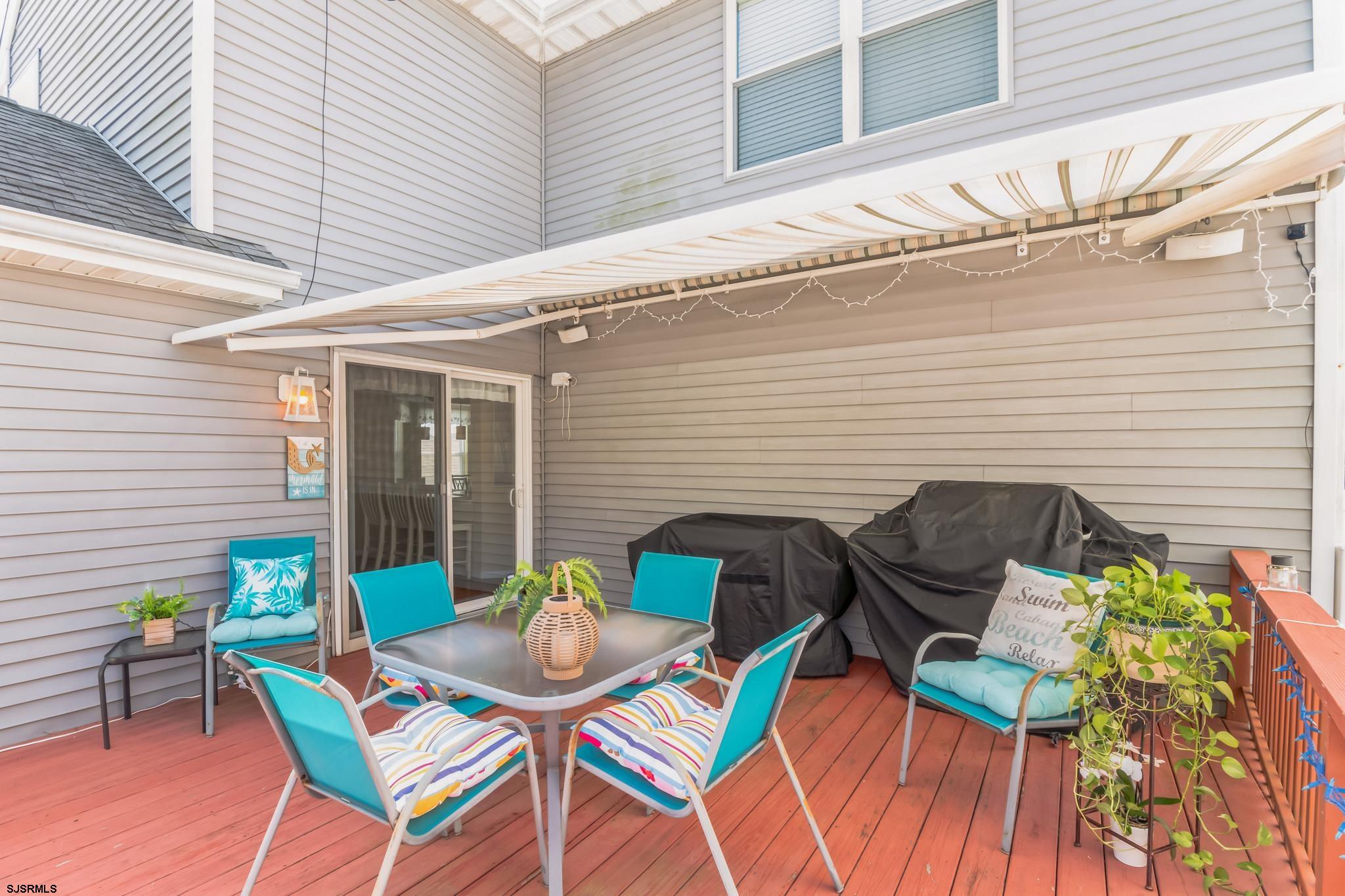 1 MacDonald Place Brigantine, NJ 08203 - Photo 26 of 36 a backyard of a house with table and chairs