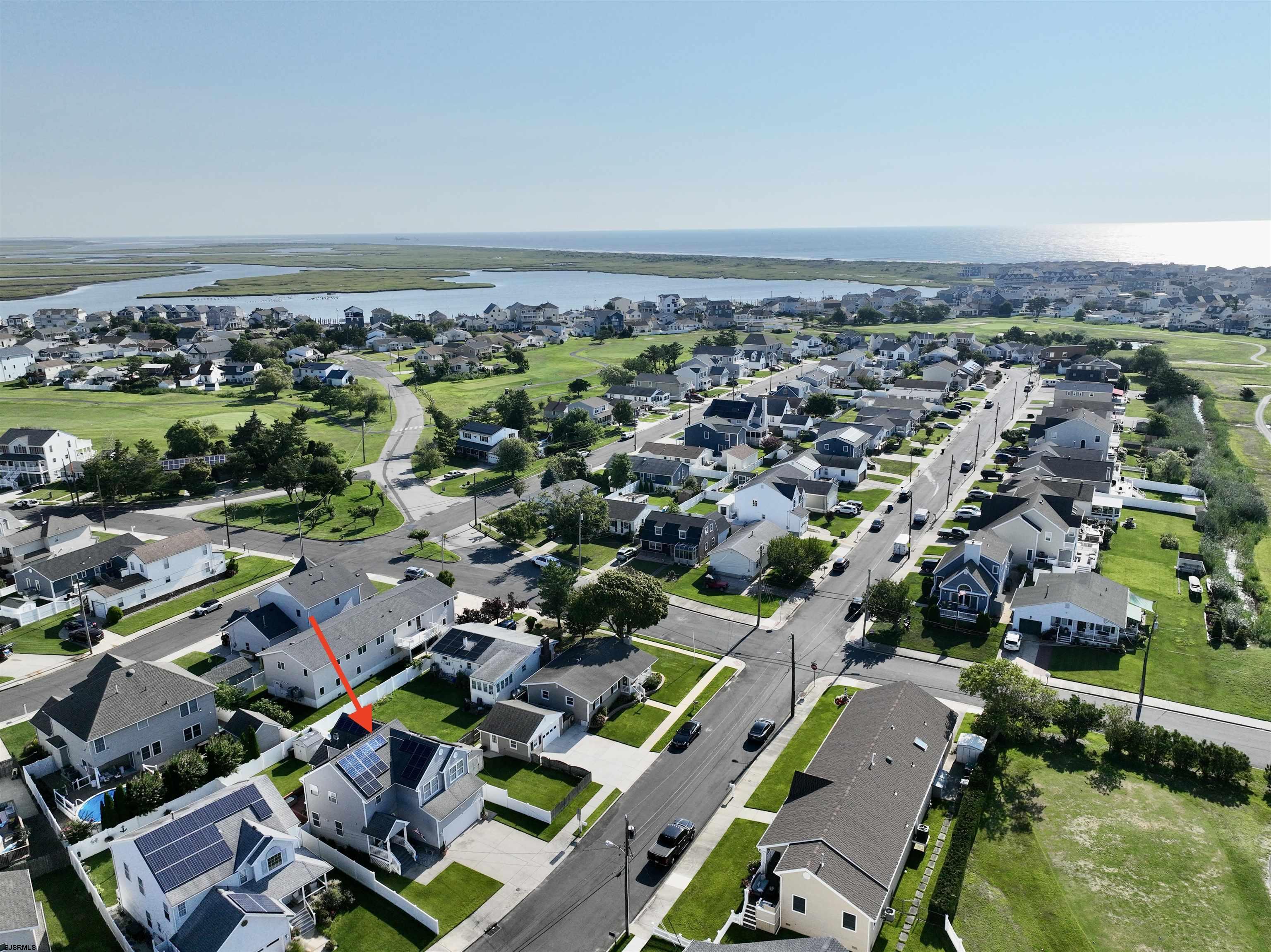 1 MacDonald Place Brigantine, NJ 08203 - Photo 3 of 36 an aerial view of a city with lots of residential buildings and mountain view in back