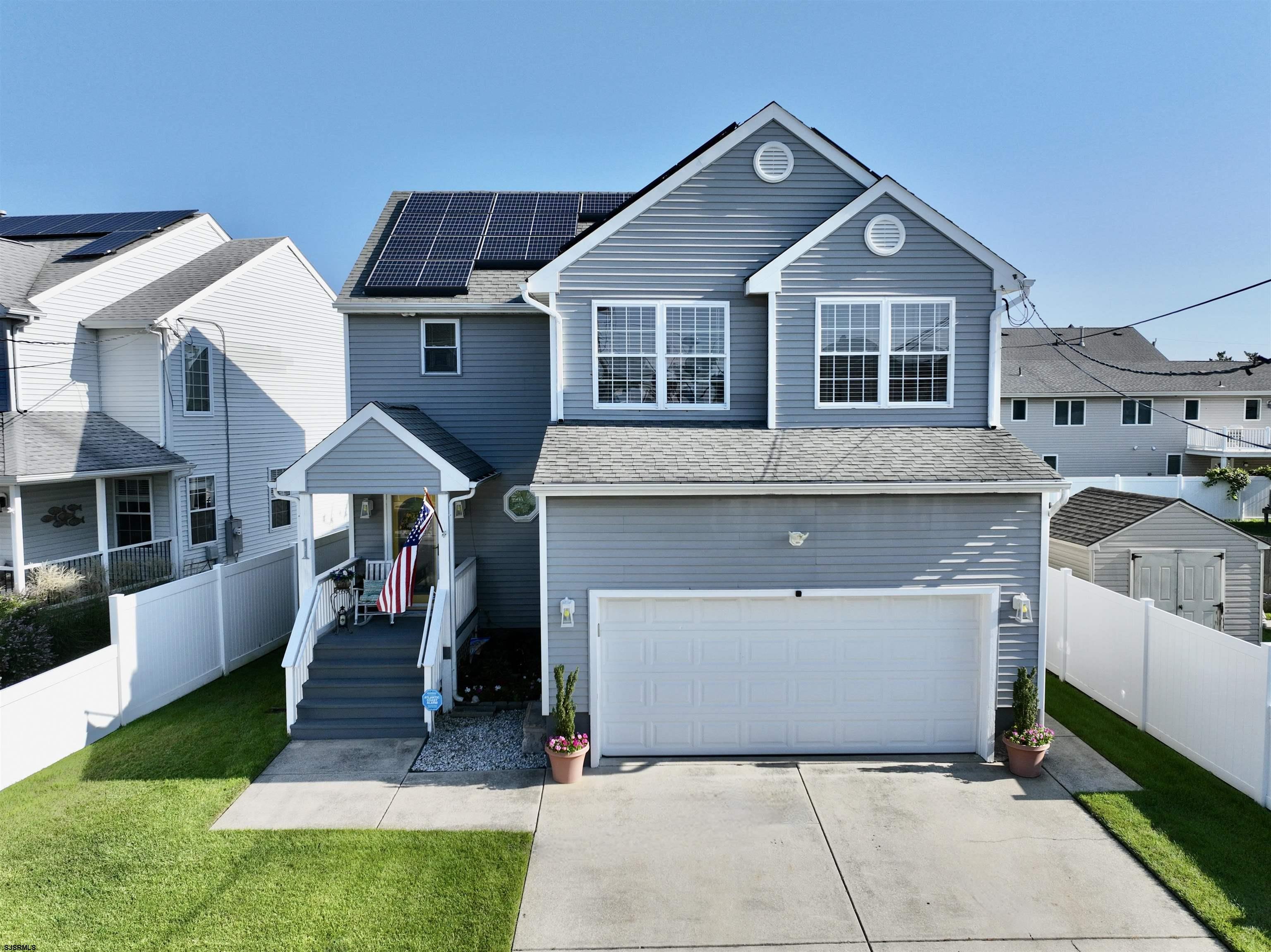 1 MacDonald Place Brigantine, NJ 08203 - Photo 4 of 36 a front view of a house with a yard and garage