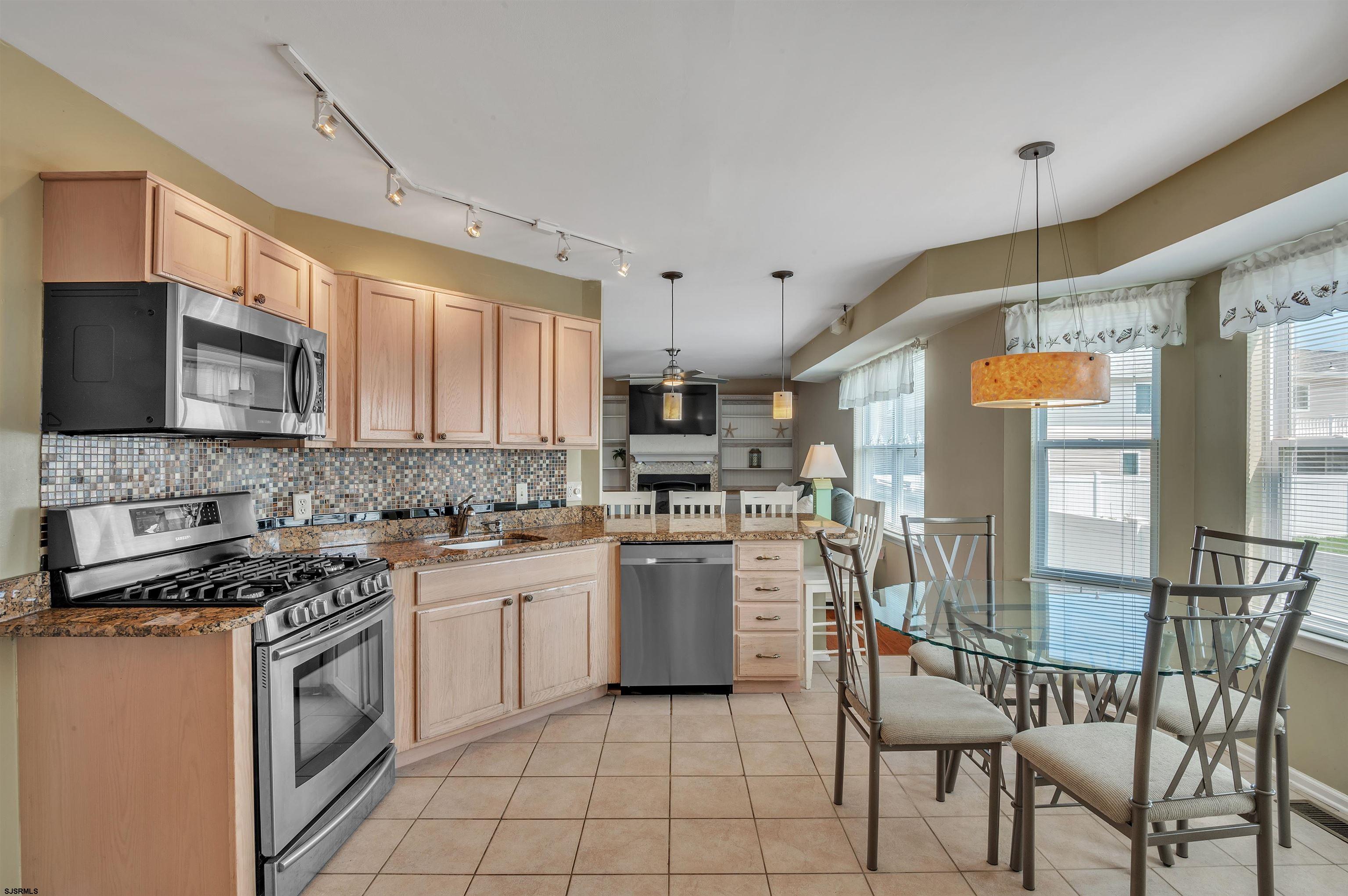 1 MacDonald Place Brigantine, NJ 08203 - Photo 10 of 36 a kitchen with a stove a sink and a microwave