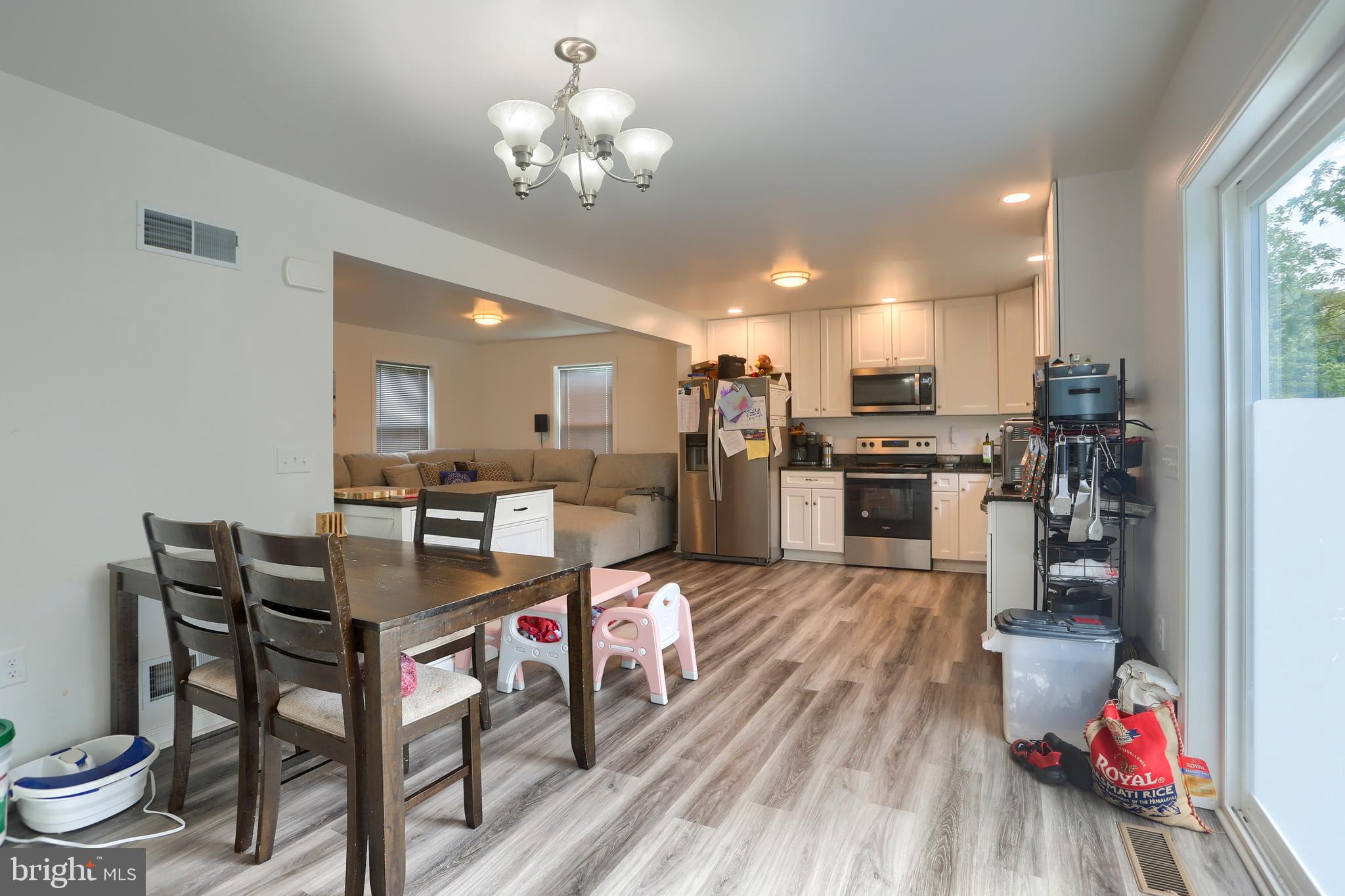 4118 Buckwheat Road Millerstown, PA 17062 - Photo 14 of 26 a living room with stainless steel appliances kitchen island granite countertop furniture a rug kitchen view and a chandelier
