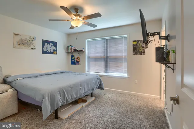 a bed room with a bed and a window