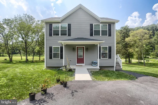 a front view of a house with a yard and porch