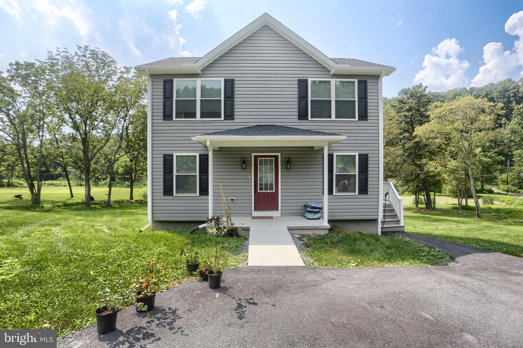 4118 Buckwheat Road Millerstown, PA 17062 - Photo 2 of 26 a front view of a house with a yard and porch