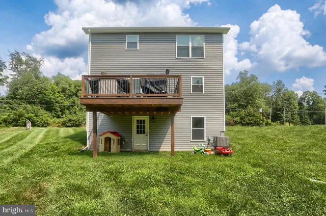 a view of a house with yard and a garden
