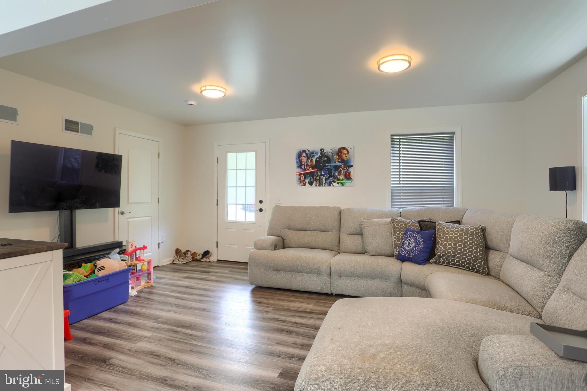 4118 Buckwheat Road Millerstown, PA 17062 - Photo 9 of 26 a living room with furniture and a flat screen tv