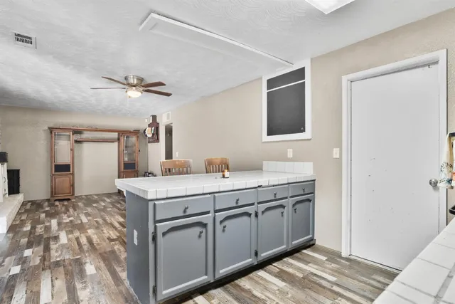 a spacious bathroom with a granite countertop sink a mirror and shower