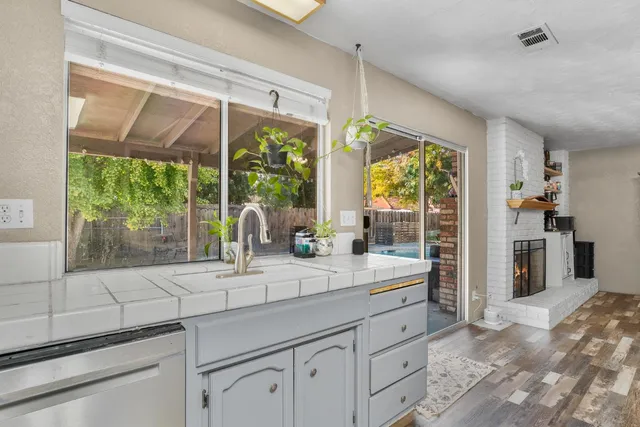 a kitchen with a sink and large window