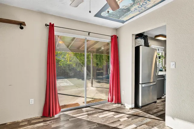 a view of a bedroom with a bed and wooden floor