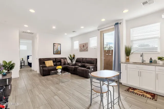 a kitchen with a table chairs refrigerator and microwave