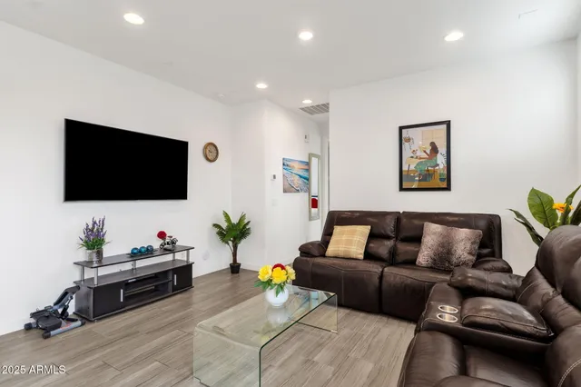 a living room with furniture and kitchen view