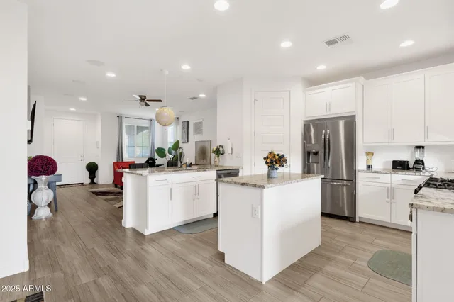 a kitchen with refrigerator a microwave a stove cabinets and a refrigerator