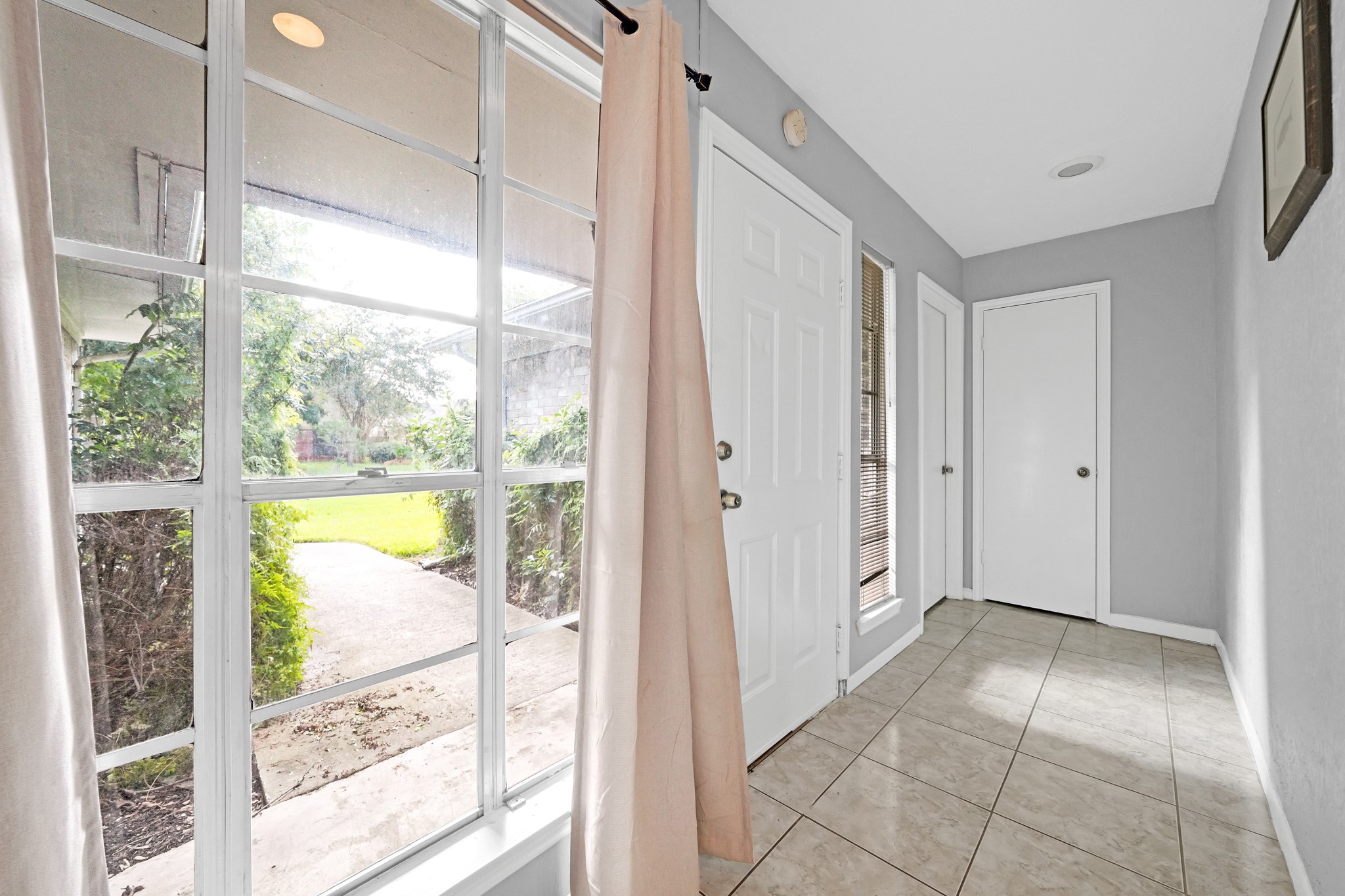 222 Wickhamford Way Houston, TX 77015 - Photo 11 of 27 a view of an entryway with wooden floor and a floor to ceiling window