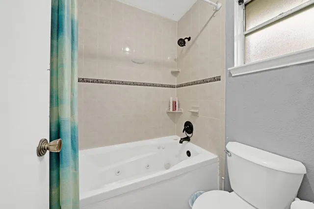 a bathroom with a toilet and a bathtub