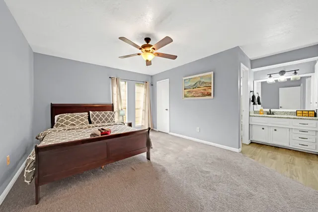 a spacious bedroom with a bed and a table