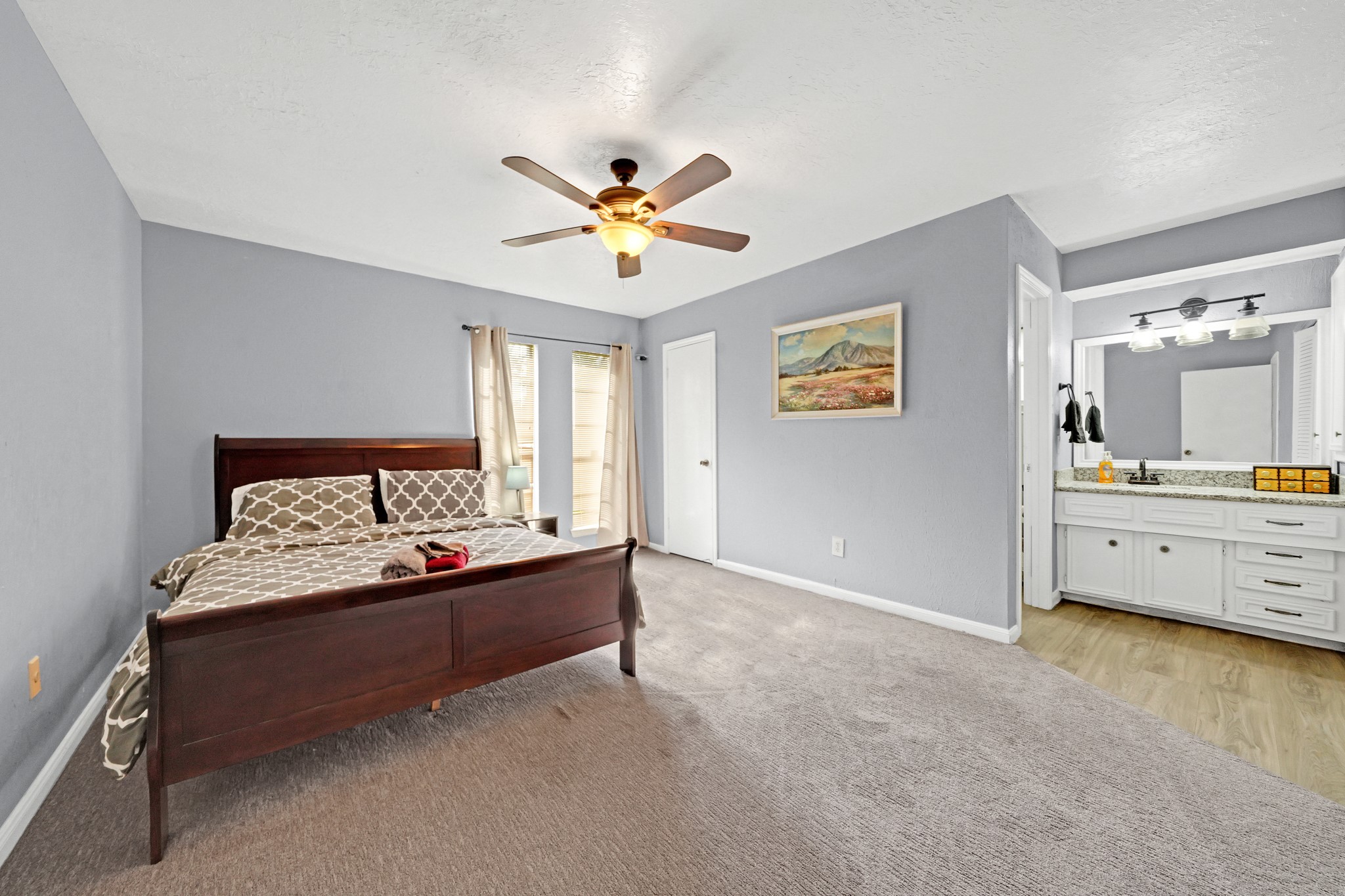 222 Wickhamford Way Houston, TX 77015 - Photo 14 of 27 a spacious bedroom with a bed and a table