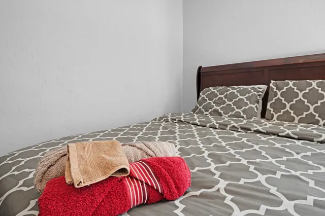 a view of a bedroom with a bed and a couch