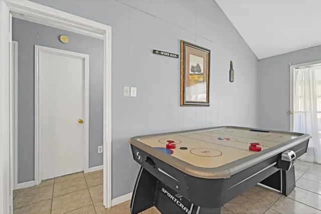 a small white bed sitting in a bedroom next to a window