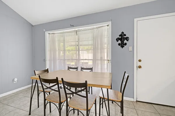 a view of a dining room with furniture and a window