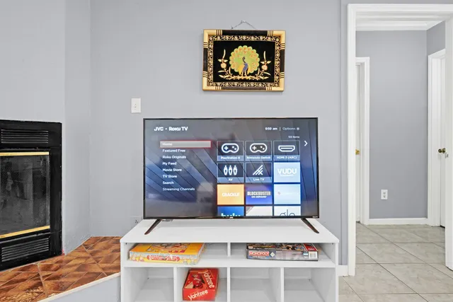 a room with painting on the wall and a dresser