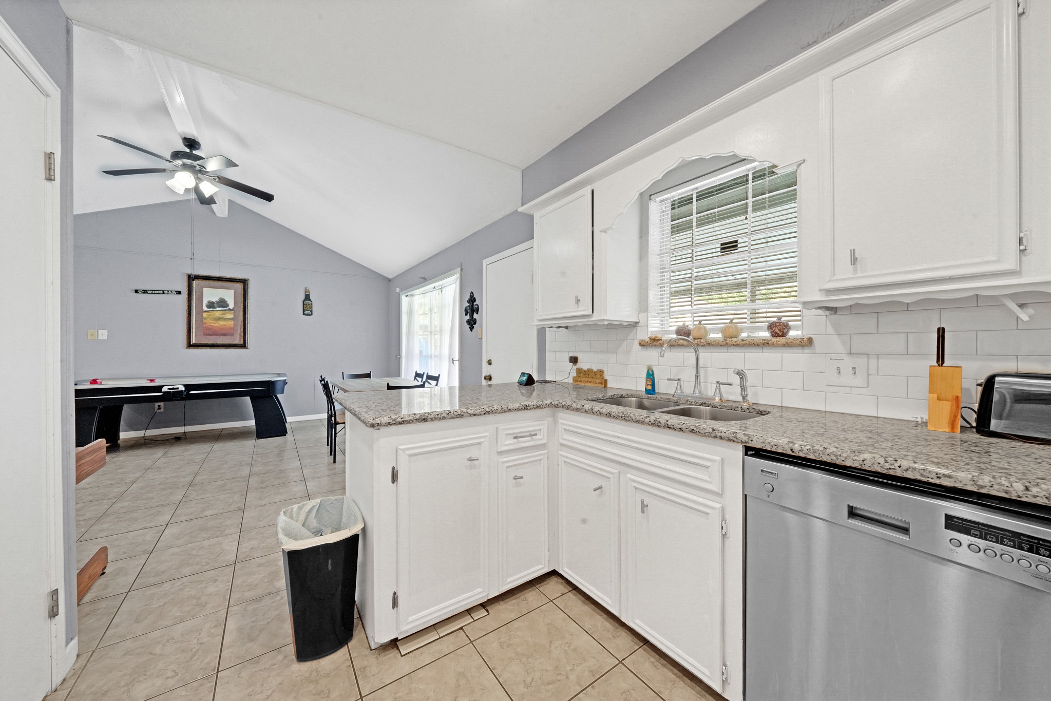 222 Wickhamford Way Houston, TX 77015 - Photo 26 of 27 a kitchen with stainless steel appliances granite countertop a sink dishwasher stove and white cabinets with wooden floor
