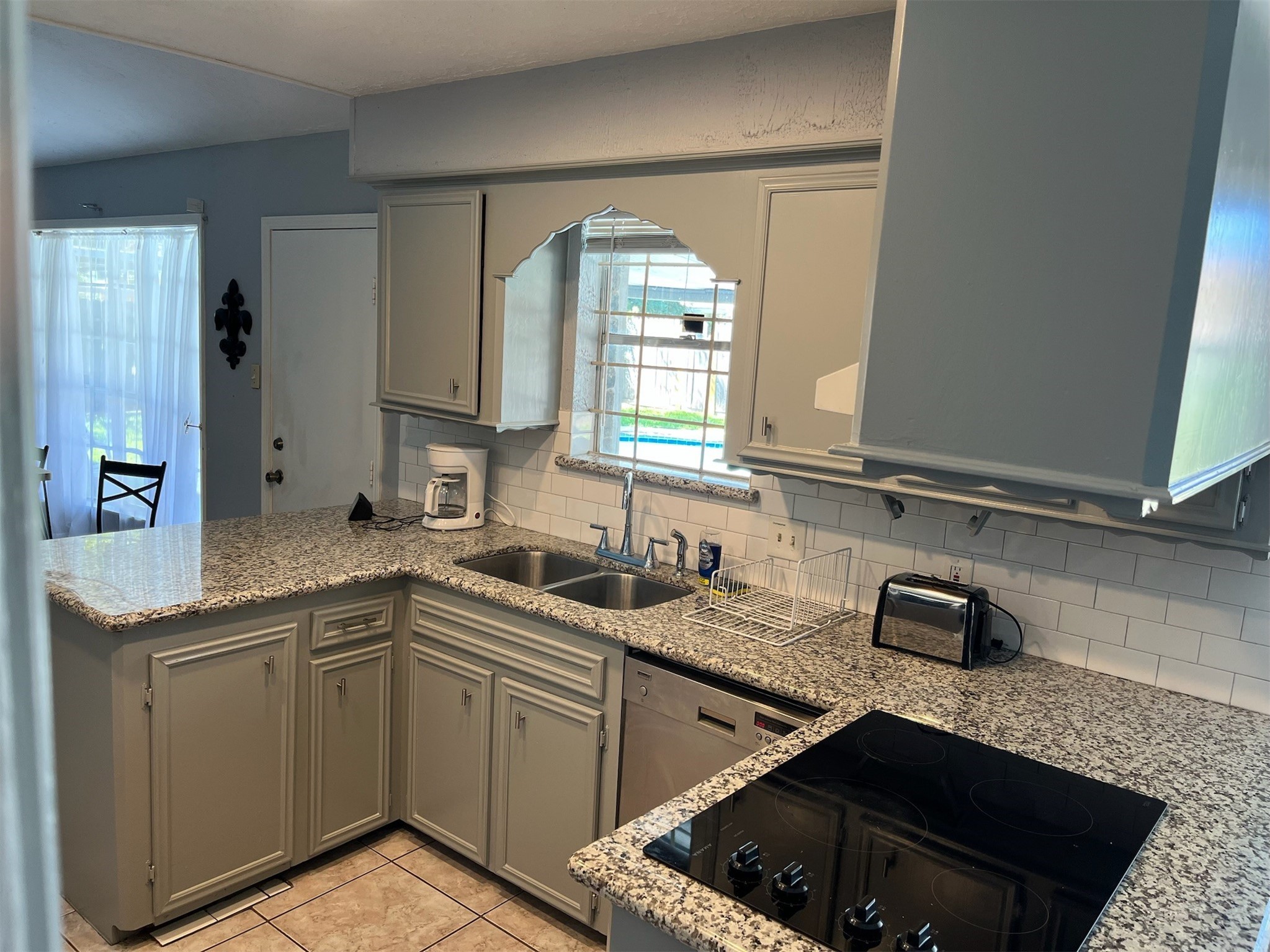 222 Wickhamford Way Houston, TX 77015 - Photo 3 of 27 a kitchen with a sink stove and cabinets