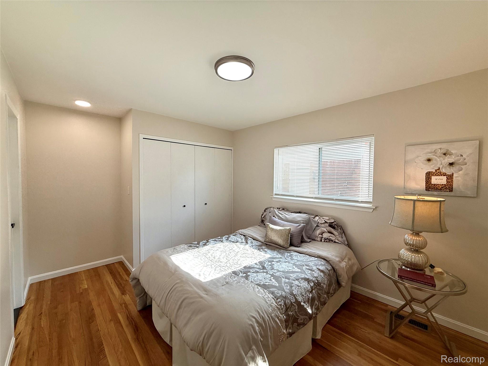 39909 Lynn Street Canton, MI 48187 - Photo 29 of 45 Bedroom featuring wood-finish flooring, a window with blinds, a double-door closet, a recessed ceiling light, and a flush mount ceiling light