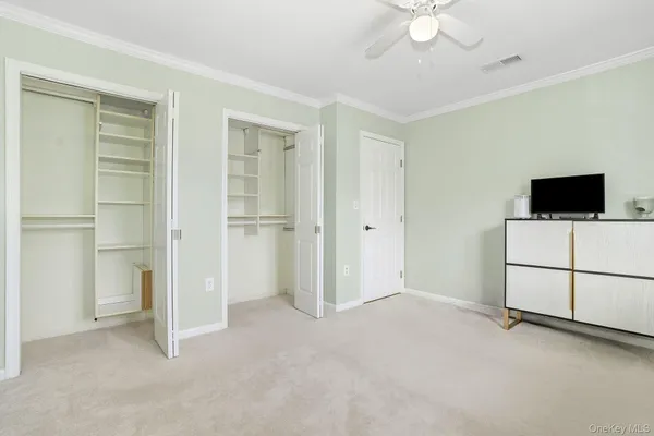a view of a livingroom with an empty space and a ceiling fan