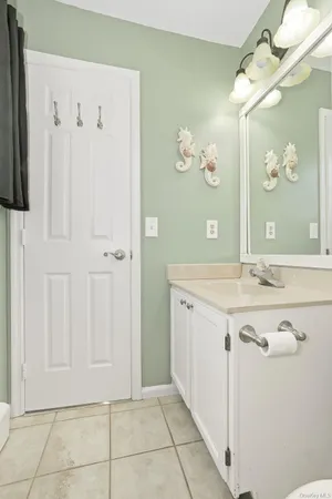 a bathroom with a granite countertop sink a mirror and a shower