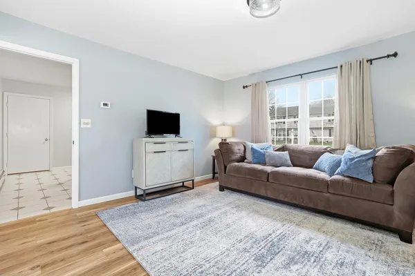 a bedroom with a bed and a large window with chair