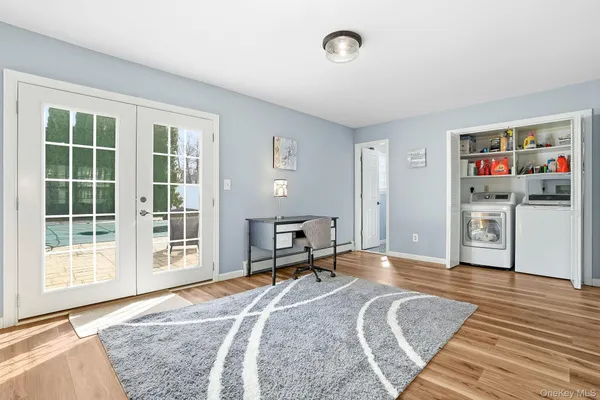 a view of a livingroom with wooden floor and furniture