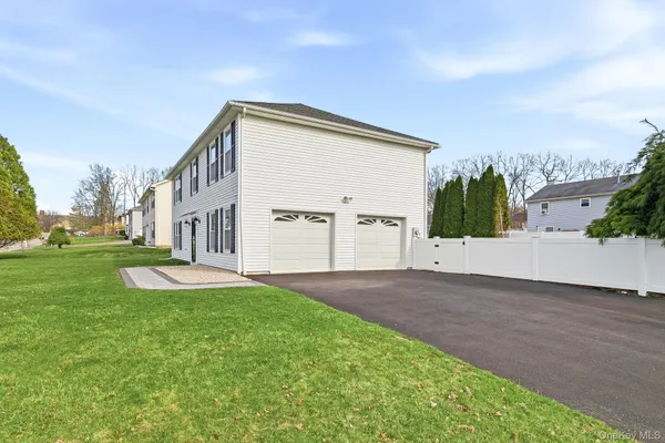 a view of a patio with couple of chairs and potted plants