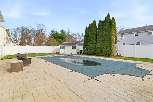a view of a swimming pool with outdoor seating