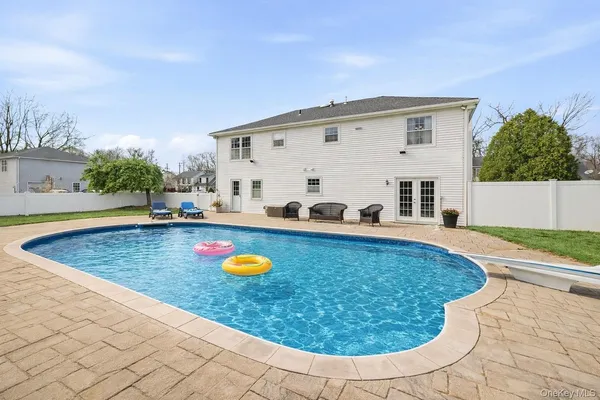 a backyard of a house with table and chairs