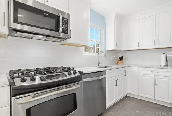 a kitchen with cabinets stainless steel appliances and a sink