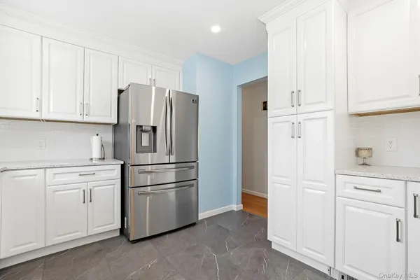 a kitchen with cabinets and stainless steel appliances
