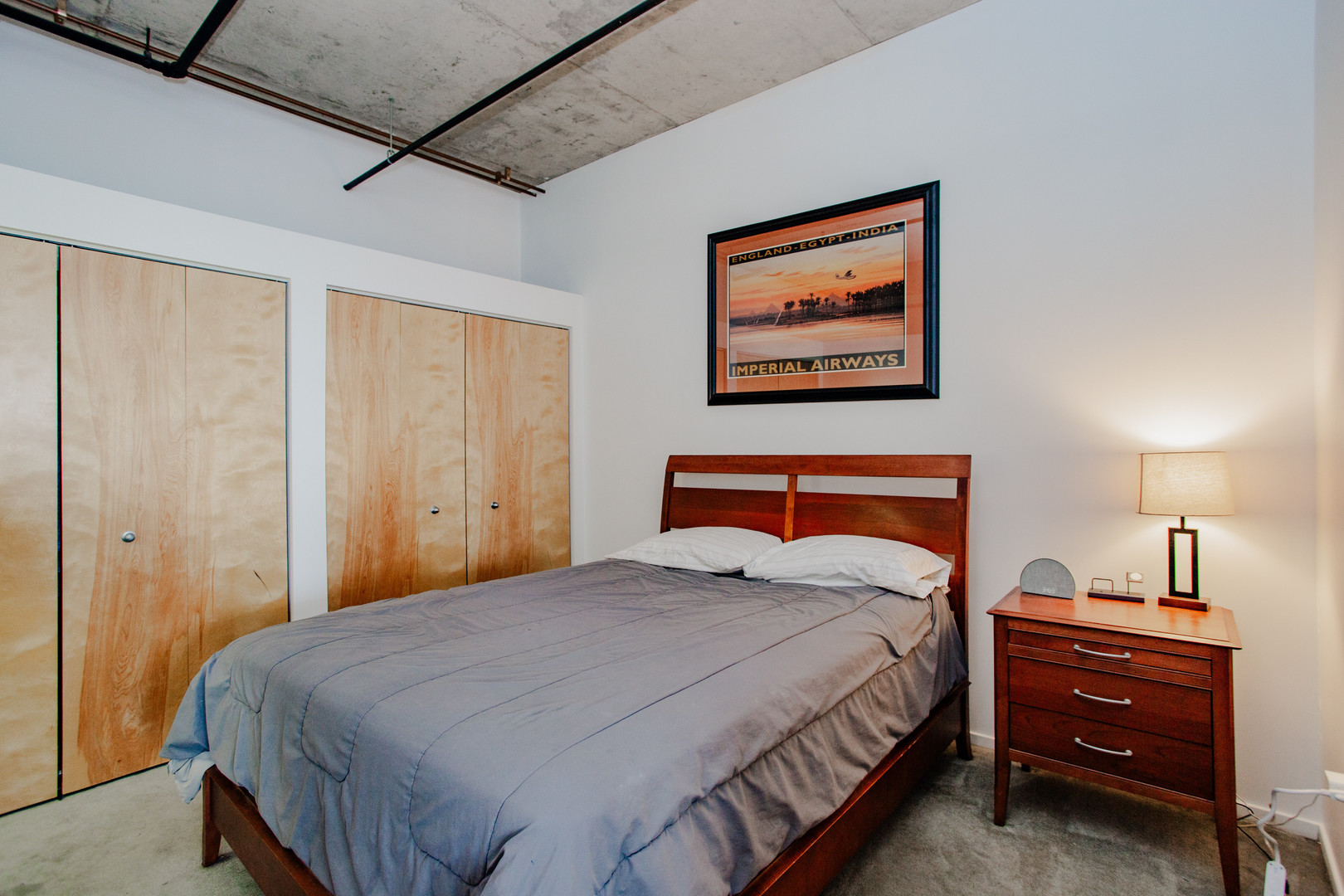 6 South Laflin Street, Unit 617 Chicago, IL 60607 - Photo 11 of 21 a bedroom with bed and paintings on the wall