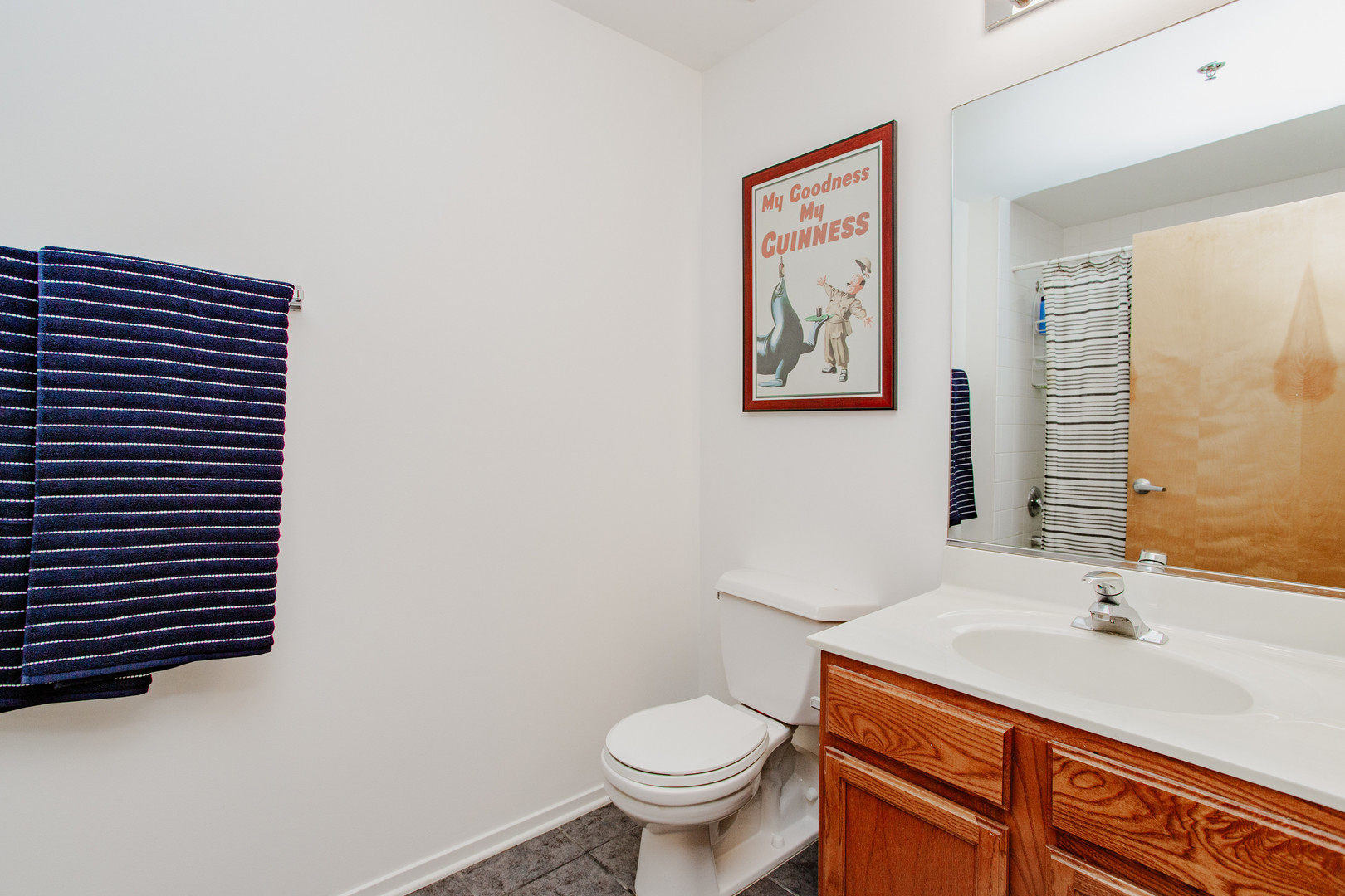 6 South Laflin Street, Unit 617 Chicago, IL 60607 - Photo 14 of 21 a bathroom with a toilet a sink and mirror