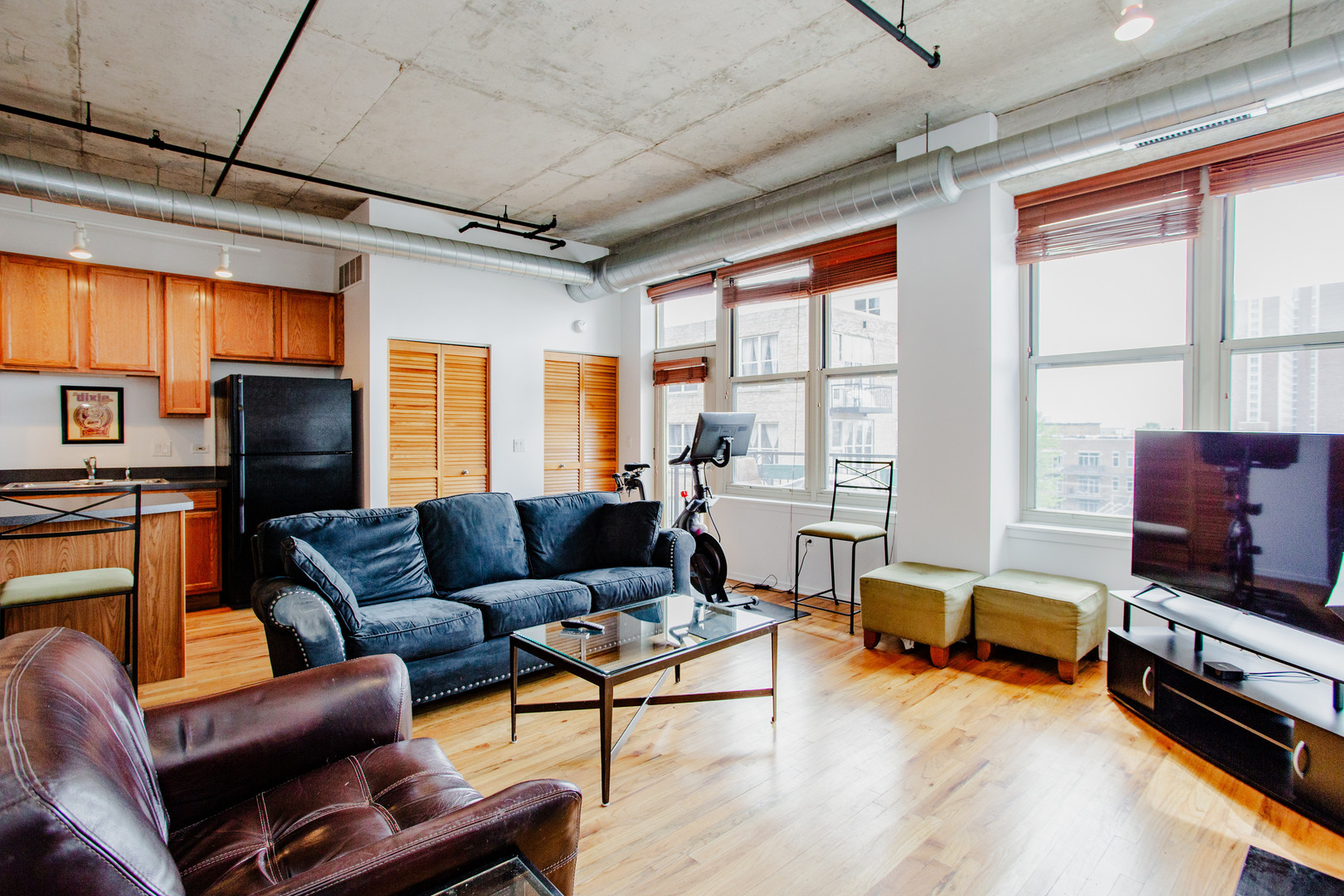 6 South Laflin Street, Unit 617 Chicago, IL 60607 - Photo 3 of 21 a living room with furniture a flat screen tv and a floor to ceiling window