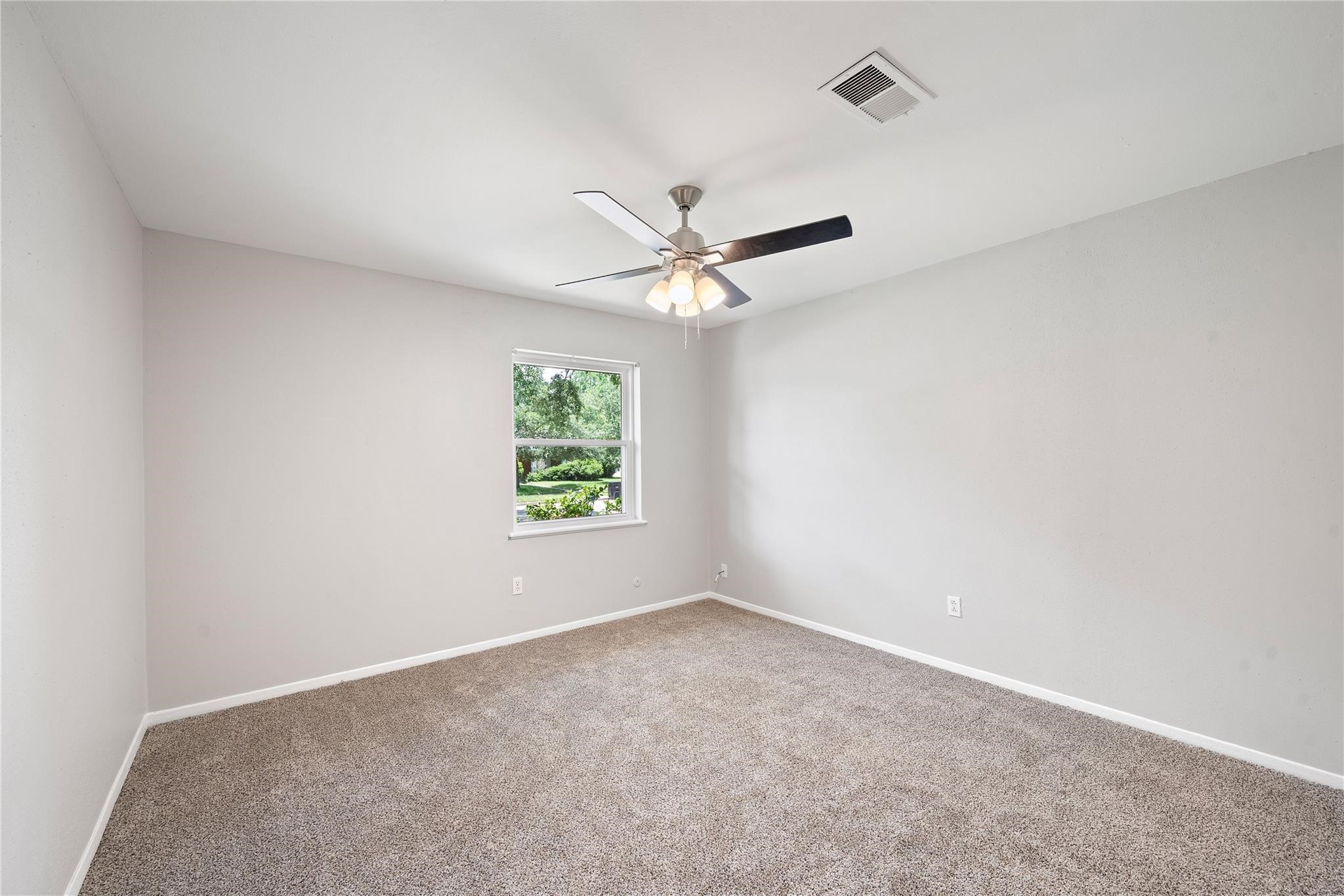 6007 Claridge Drive Houston, TX 77096 - Photo 14 of 38 an empty room with window and ceiling fan