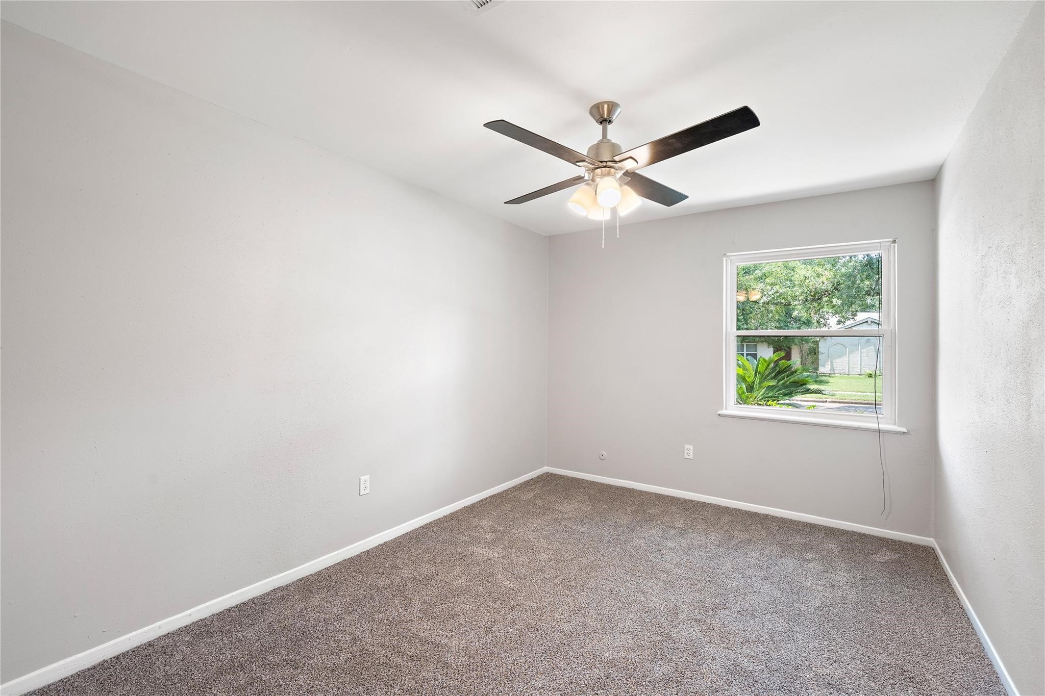 6007 Claridge Drive Houston, TX 77096 - Photo 15 of 38 an empty room with a window and a fan