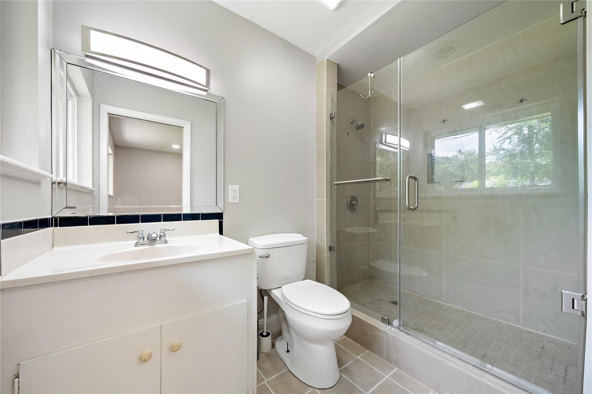 6007 Claridge Drive Houston, TX 77096 - Photo 20 of 38 a bathroom with a sink a toilet and shower