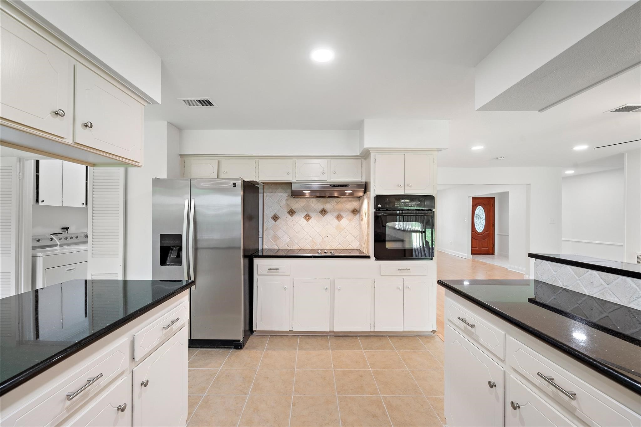 6007 Claridge Drive Houston, TX 77096 - Photo 2 of 38 a kitchen with granite countertop a refrigerator and a sink