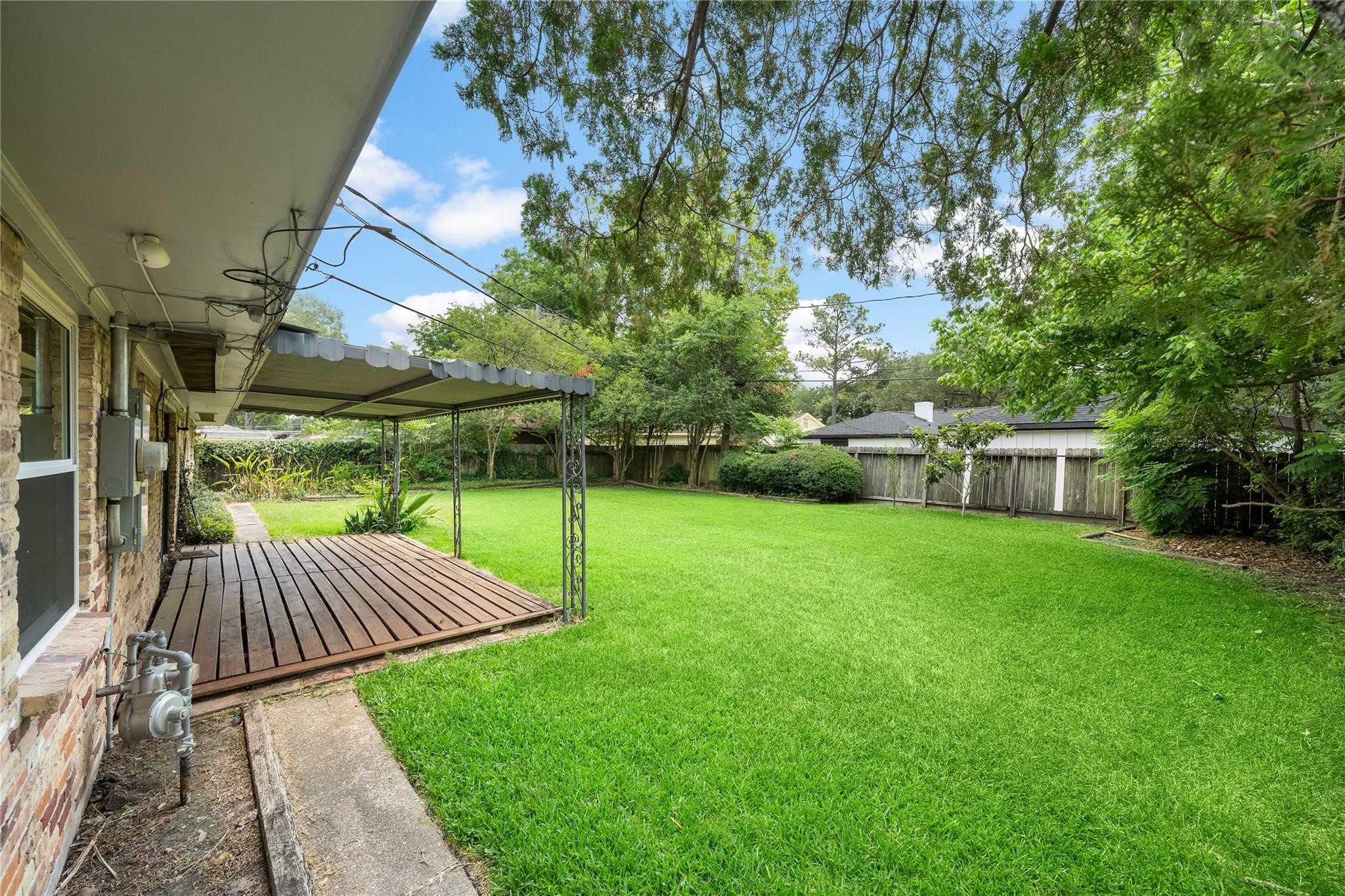 6007 Claridge Drive Houston, TX 77096 - Photo 21 of 38 a view of backyard with a patio and entertaining space